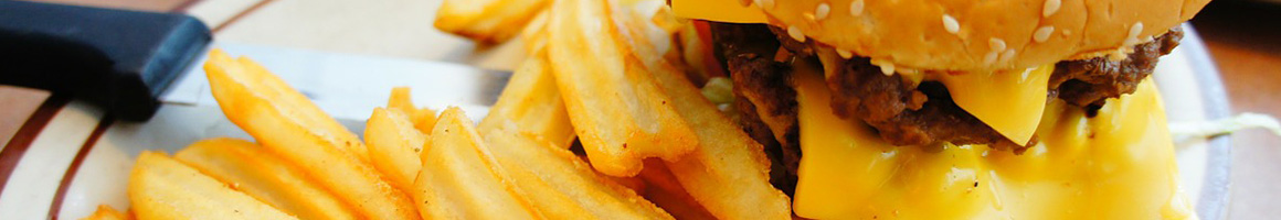 Eating American (Traditional) Burger Hot Dog at Dave's Burger Barn restaurant in Waco, TX.